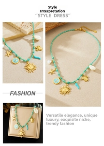 Detail of teal braided necklace featuring gold sun, moon, and starfish enamel charms