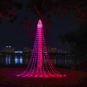 Macro detail of magenta LED star tree waterfall lights hanging in an outdoor night setting
