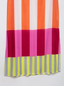 Close-up of vibrant striped pattern fabric with split hem detail on a slim fit dress