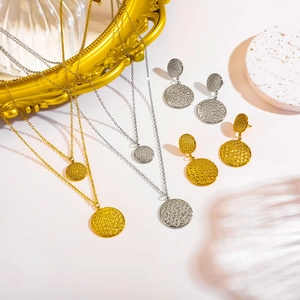 Modern double-layered gold and silver necklace and earring set with textured round charms