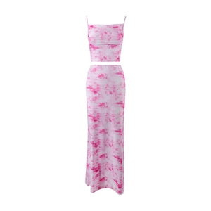 Detailed view of pink marble print two-piece set featuring crop top and long skirt