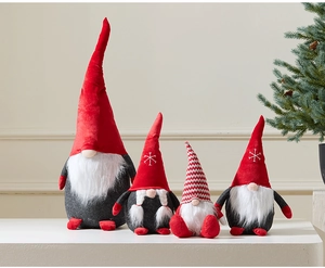 Detail of four festive Christmas gnomes with knitted hats and soft faux fur beards on display