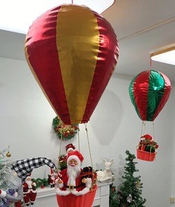 Detailed indoor view of hot air balloon Santa Claus ornaments with red and gold fabric