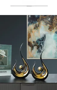 Detail of modern abstract black and gold ceramic sculptures for luxury living room decor