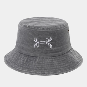 Detailed view of embroidery logo on vintage washed grey cotton bucket hat fabric