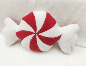 Detail of red and white spiral stripe candy plush pillow with soft sherpa fabric texture