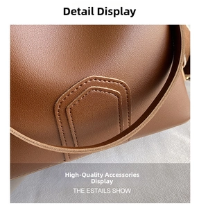 Detail of brown litchi pattern leather bag showing precise stitching and strap connection