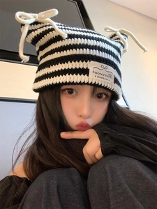 Detail of black and white striped knit beanie with cat ears and Pierced handmade label