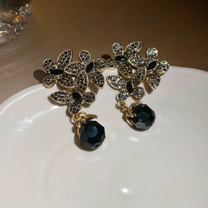 Detail of vintage black crystal flower earrings with sparkling rhinestones and bead drop
