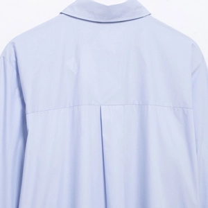 Back view of light blue striped long sleeve shirt showing collar and shoulder stitching