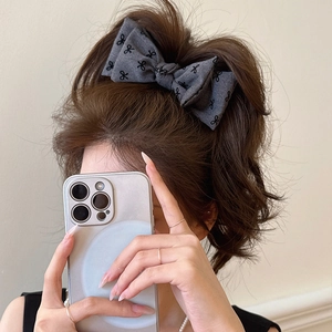 Grey floral double-layered bow hair clip styled on a high ponytail for women