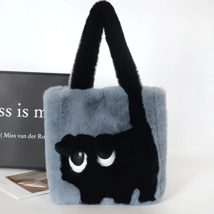 Detail of soft faux rabbit fur texture and cute black cat pattern on the plush tote bag