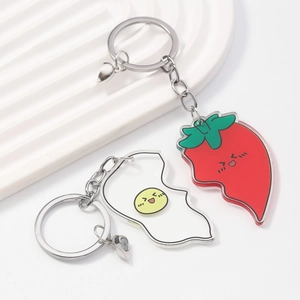 Detailed view of creative magnetic fried egg and chili pepper acrylic keychains set