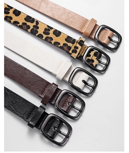 Detail showing five PU leather belts in leopard, camel, and black with bronze buckles