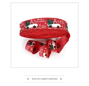 Detail of red Christmas ribbon with white truck, green tree and snowflake patterns