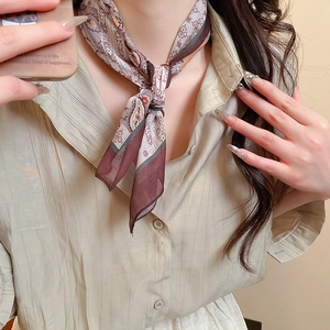 Close-up of a paisley silk scarf necklace in vintage brown and red silk tones