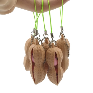 Macro detail of creative peanut fidget toy keychain with funny expression and green strap