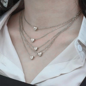 Silver multi-layer heart initial necklace with engraved letters K N J T Q on charms