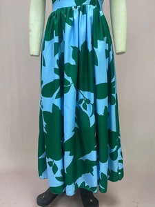 Detail of leaf print dress showing blue and green botanical pattern on fabric