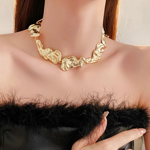 Close-up of a wide gold choker featuring an irregular liquid metal design for women