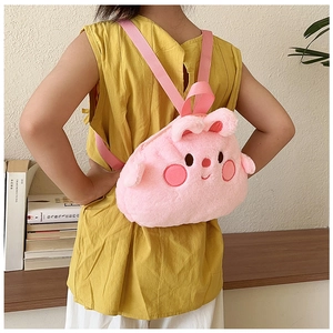 Pink plush cartoon backpack for kids shown on model in a cozy indoor setting