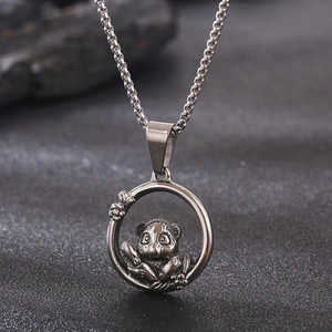 Detailed macro view of the silver panda animal pendant and stainless steel chain link