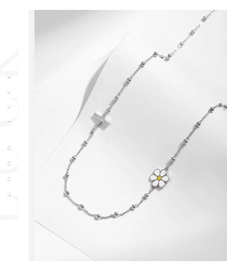 Close-up of s925 silver beaded choker with crystal cross and white daisy charms