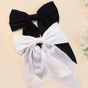 Set of 2 large solid color fabric bow hair clips with long ribbons in black and white