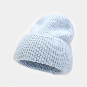 Close-up of soft ice blue angora rabbit fur beanie with thick ribbed knit texture