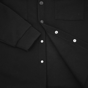 Macro detail of high-quality metal snap buttons on black slim fit casual jacket