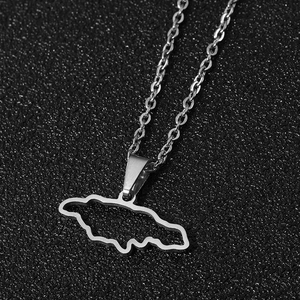 Macro shot of silver stainless steel Jamaica island map pendant necklace on black background