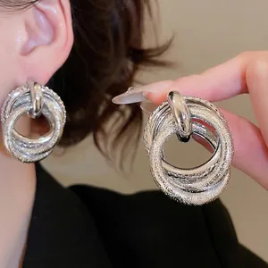 Minimalist silver irregular multi-layer hoop earrings with textured metallic finish