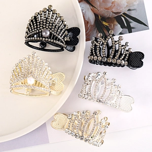 Detailed view of crown hair clips with sparkling rhinestones and elegant pearls