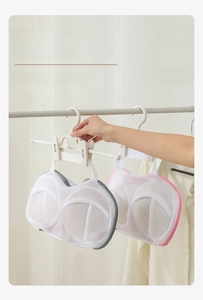 Mesh bra laundry bag with hanging loop shown on a hanger for easy drying and protection