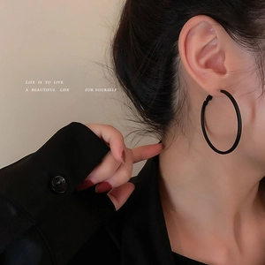 Minimalist matte black large hoop earrings for women in a modern industrial style