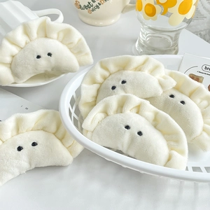 Cute dumpling plush keychain charms in a basket with minimalist Japanese style