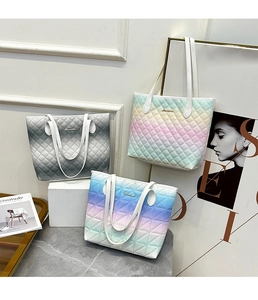 Detailed display of three quilted tote bags in gradient gray, rainbow, and blue purple colors