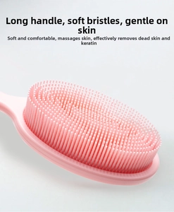 Detail of pink silicone bath brush with soft bristles for gentle exfoliation and massage