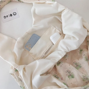 Detailed macro view of embroidered floral canvas tote bag showing the zipper inner pocket