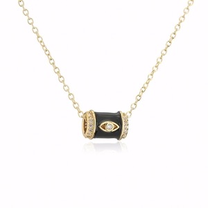 Detail of 18K gold plated cylinder pendant featuring enamel eye motif and zircon stones