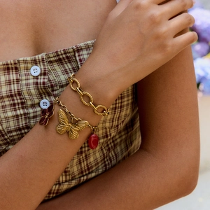 Layered gold plated stainless steel bracelets with butterfly and floral charms