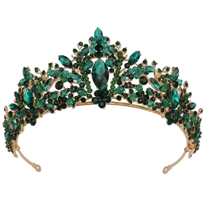 Detail of bridal crown with green crystals and leaf-shaped rhinestones on metal base