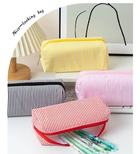 Detailed view of colorful seersucker pencil cases showing textures and large capacity