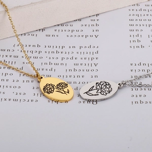 Detailed close-up of oval stainless steel pendants with engraved floral patterns