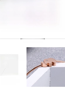 Detailed macro view of a rose gold 316L stainless steel elephant bracelet with tiny diamond