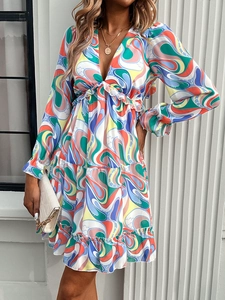 Detail of V-neck long sleeve dress with colorful abstract waves and ruffle cuffs
