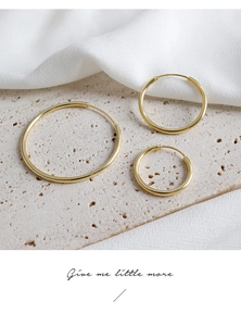 Detailed view of three minimalist S925 sterling silver gold-plated hoop earrings in various sizes