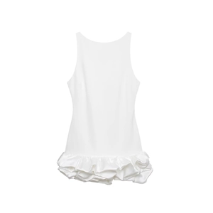 Detailed view of white sleeveless dress showing silky satin texture and pleated ruffled hem