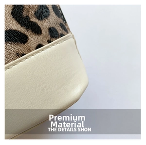 Close-up of leopard print fabric and off-white leather with detailed stitching