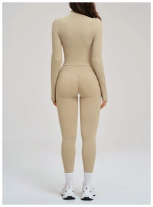 Detail view of the back fit and stretch fabric on a beige yoga set with zipper jacket